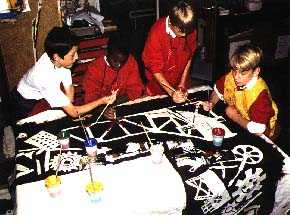 Year 6 hand painting their printed shapes
