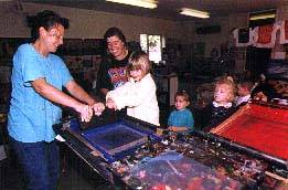 Cloth of Gold artist using carousel with children