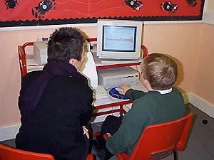 pupil working with Viv on design in Bannermania
